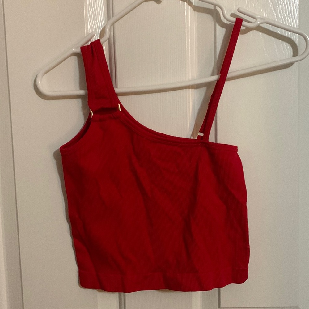A red cropped sort of off the shoulder shirt from Suzette Collection.